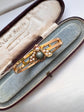 CHUNKY 15CT GOLD BANGLE WITH A LARGE GEM SET FLY