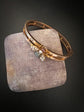 CHUNKY 15CT GOLD BANGLE WITH A LARGE GEM SET FLY