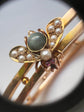 CHUNKY 15CT GOLD BANGLE WITH A LARGE GEM SET FLY