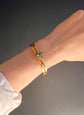 CHUNKY 15CT GOLD BANGLE WITH A LARGE GEM SET FLY