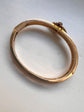 CHUNKY 15CT GOLD BANGLE WITH A LARGE GEM SET FLY