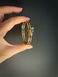 CHUNKY 15CT GOLD BANGLE WITH A LARGE GEM SET FLY