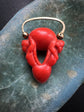 EARLY 19TH CENTURY CORAL CHERUB PADLOCK PENDANT